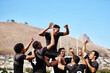 © peopleimages.com - Celebration, sports and winner with rugby player team outdoor on field for motivation or success. Exercise, fitness and high five with group of friends cheering at venue for achievement or victory