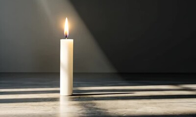 Canvas Print - A solitary candle casting shadows in a dimly lit space.