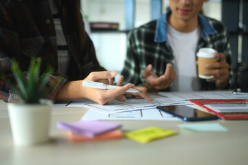 App developer team analyzing app layouts and discussing ideas co working space