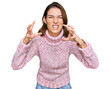 © Krakenimages.com - Young caucasian girl wearing wool winter sweater shouting frustrated with rage, hands trying to strangle, yelling mad