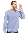 © Krakenimages.com - Young caucasian man wearing casual clothes shouting and screaming loud to side with hand on mouth. communication concept.