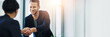 © peopleimages.com - Business, people and handshake in office with agreement in investment deal, funding proposal success or welcome. Space, financial advisor and shaking hands in collaboration of partnership with banner