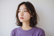 © AI Camera - Young Asian Woman with Natural Beauty and Soft Expression in Purple Sweater