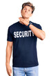 © Krakenimages.com - Young handsome man wearing security t shirt cutting throat with hand as knife, threaten aggression with furious violence