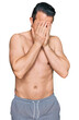 © Krakenimages.com - Handsome young man wearing swimwear shirtless with sad expression covering face with hands while crying. depression concept.