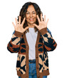 © Krakenimages.com - Middle age hispanic woman wearing casual clothes showing and pointing up with fingers number ten while smiling confident and happy.