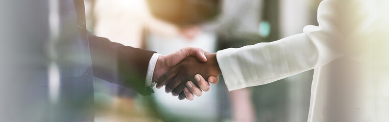 Fototapete - Handshake, banner and hands of business people in office for teamwork, collaboration and partnership. Corporate, professional and workers with deal gesture for agreement, b2b networking or thank you