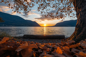 Wall Mural - sunset over a lake with mountain view framed by autumn trees and fallen leaves. fall background
