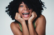 © deagreez - Excited young woman expressing joy and confidence in a cheerful studio portrait
