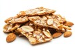 © Dmitrii - Delicious homemade almond brittle stacked on a white surface showcasing a sweet treat