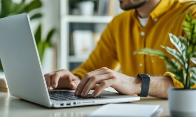Aufkleber - A person typing on a laptop at a desk surrounded by plants.