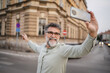 © Miljan Živković - senior man walk on the street and talk on video call on cellphone