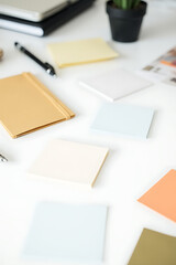 Aufkleber - Notes with assorted writing accessories lie scattered across a clean white desktop in a minimalist office setting._00002_