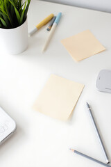 Aufkleber - Notes with assorted writing accessories lie scattered across a clean white desktop in a minimalist office setting._00001_