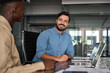 © insta_photos - Two busy happy business men working on computers discussing online project data at work. Diverse professional workers developers team talking on finance software technology using laptops in office.