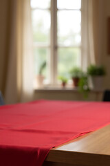 Poster - A red tablecloth lies on a wooden surface in front of a blurred home window background view._00002_