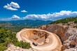 © Sanchai - A wide shot of an open-pit diamond mine, with terraced excavation levels and trucks navigating the spiral road