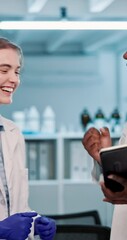 Wall Mural - People, scientist and happy with high five on tablet at laboratory for success on science investigation. Employees, medical professionals and excited with celebration for test results and research