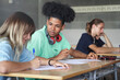 © EFStock - African American Secondary school student writing notes during exam class at the High School or College