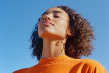 Aufkleber - A woman with her eyes closed, gazing upwards, possibly in contemplation or prayer