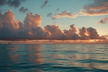 Wall Mural - a single boat floats on calm waters during sunset, with a clear blue sky and orange hues
