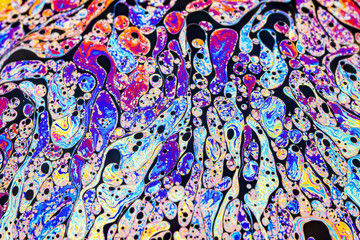 Wall Mural - Real photograph of a colorful light interference on a soap bubble surface with random swirls, curves and lines