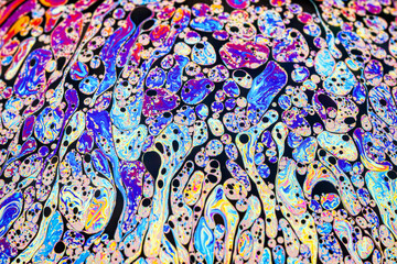 Wall Mural - Real photograph of a colorful light interference on a soap bubble surface with random swirls, curves and lines