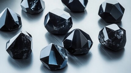 Aufkleber - A variety of polished black gemstones are displayed closely together on a reflective surface.