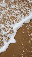 Poster - White sea foam creating intricate patterns on the wet golden sand of a pristine beach, evoking a serene and relaxing atmosphere in a beautiful summer seascape
