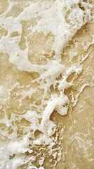 Poster - Gentle waves create intricate patterns of white sea foam as they wash over the smooth golden sand of a tropical beach, offering a tranquil and inviting scene of coastal beauty