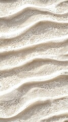 Poster - Gentle waves deposit delicate sea foam on the shore, creating intricate patterns on the wet sand, offering a tranquil and mesmerizing coastal scene