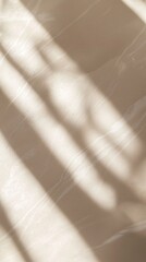 Poster - Soft sunlight streams through a window, casting an elegant, abstract pattern of light and shadow on a textured wall, creating a serene and minimalist backdrop
