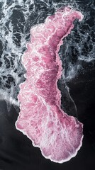 Aufkleber - Endless sea waves crash against the striking black sand beach, creating a captivating display of vibrant pink foam illuminated by the soft light of sunset. Nature’s artistry unfolds