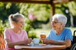 © Design Depot - Two older women, seated outdoors, share a joyful conversation while holding coffee cups, capturing a moment of companionship and happiness.