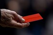 © PaulShlykov - Referee shows red card during an intense soccer match in a stadium filled with passionate fans in the afternoon