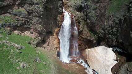 Wall Mural - Orbital aerial shot of Gagharot waterfall on sunny summer day. Mount Aragats, Armenia.