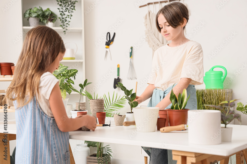 Cute children planting at table in workshop