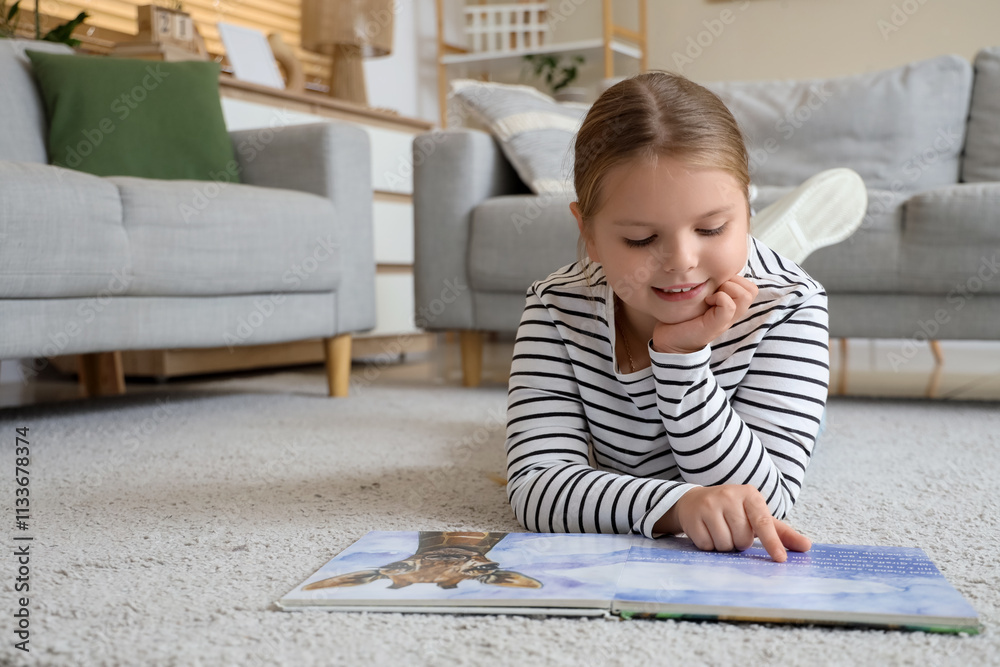 Funny little girl reading book at home