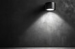 © Abusufyan - Black spotlight illuminates dark textured wall.