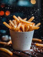 Poster - Crispy golden fries are piled high in a white cup, creating a tempting snack on a wooden table amidst a soft bokeh background. Generative AI