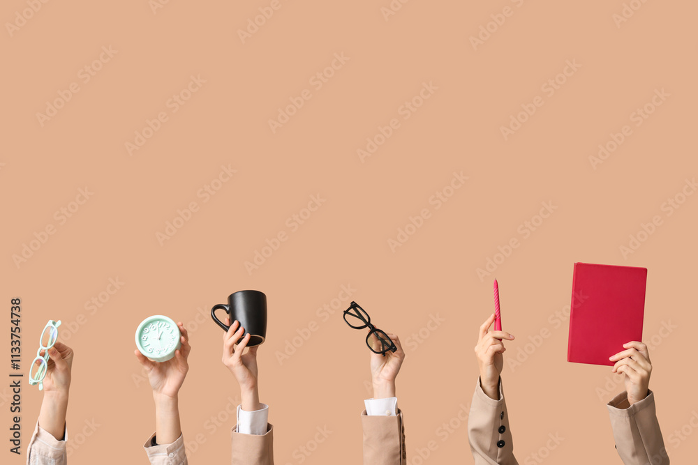 Female hands with eyeglasses, alarm clock, cup and notebook on beige background. Time management concept