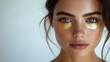 © tengah - A close-up of a woman with gold eye patches, emphasizing skincare and beauty.