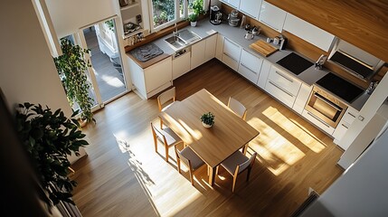 Poster - Modern kitchen with wooden accents and a dining table bathed in sunlight.