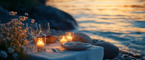 Aufkleber - Romantic dinner setup by the water at sunset with candles and flowers.