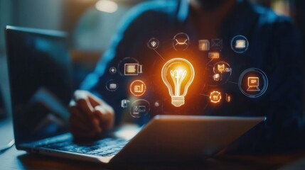 Aufkleber - A person working on a laptop with a glowing light bulb symbolizing ideas and innovation.