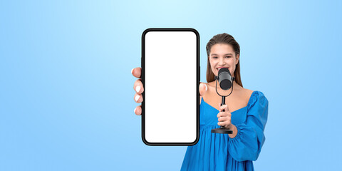 Poster - Woman in a blue blouse holding a smartphone with a blank screen
