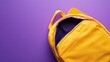 © milenialdesastudio - Open yellow backpack on a vibrant purple background.