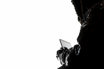 Poster - Silhouette of hooded figure using laptop.
