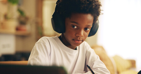 Poster - Video, home and child with headphones, tablet and boy with information, education and studying for exam. Desk, growth and development of African kid, listening and podcast for knowledge at house