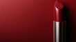© familymedia - An elegant single red lipstick is placed against a textured base, highlighting its smooth and glossy surface, evoking sophistication and timeless beauty.